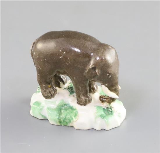 A Rockingham porcelain figure of an elephant, c.1830, L. 4.7cm, restorations